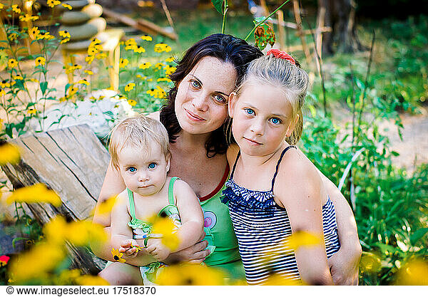 mom in the garden and two daughters