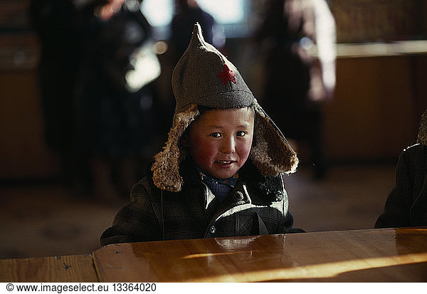 MONGOLIA People Children Child in shop wearing hat with long ear flaps