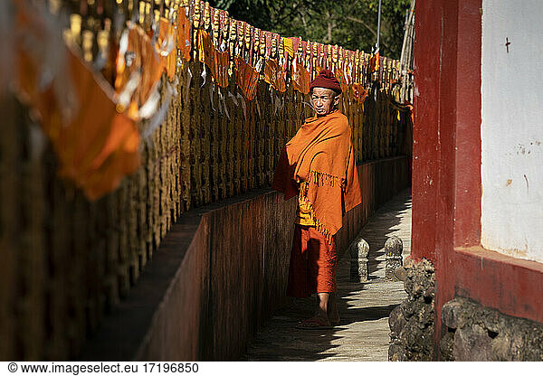 Monk dressed in saffron robe standing by Ko Yin Lay Monastery near Kengtung  Myanmar