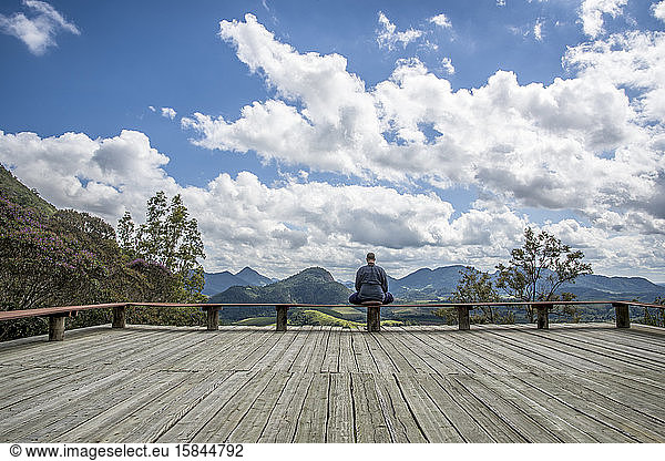 Monk meditating in a house among the mountains