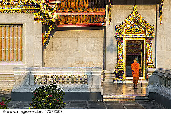 monk walking into the famous temple Wat Benchamabophit in Bangkok