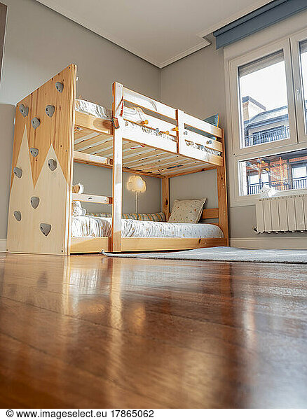 Montessori children's room with bunk bed and climbing wall
