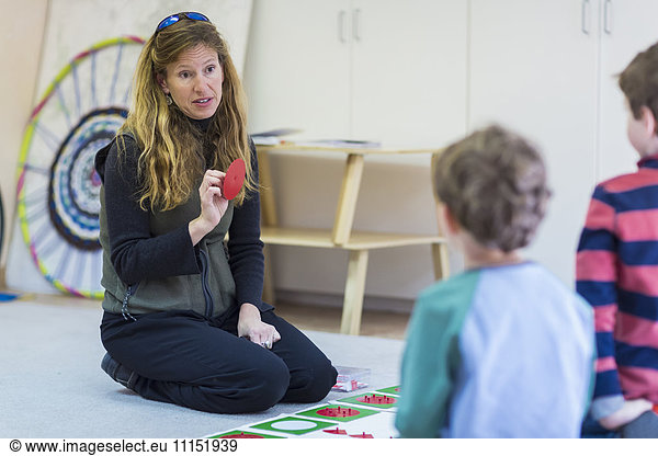 Montessori teacher talking to students in classroom