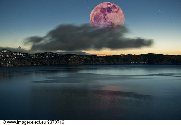 Moon over dark cloud at Crater Lake  Oregon  United States