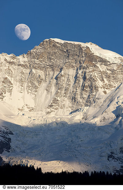 Moon over Jungfrau Mountain  Bernese Oberland  Switzerland  Europe