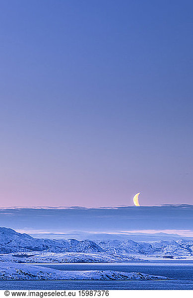 Morning mood with moon in winter  Lebesby  Lakse Fjord  Norway
