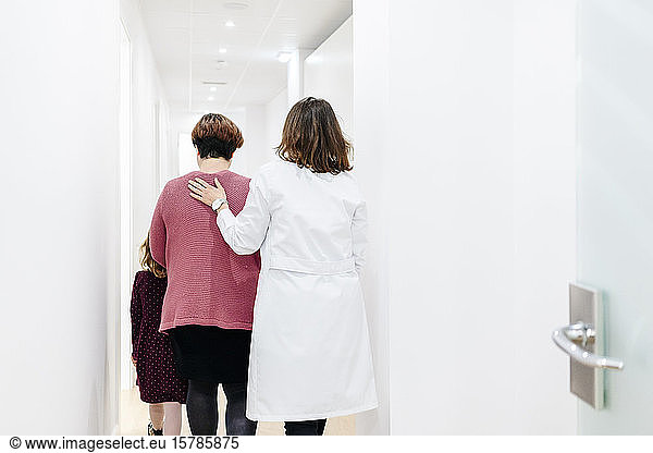 Mother and daughter entering medical practice