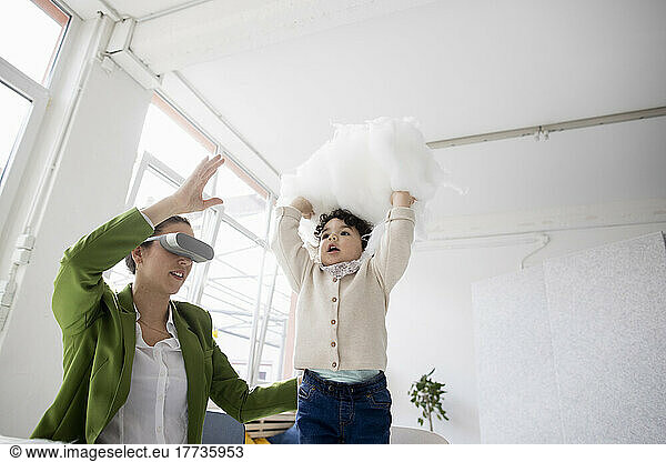 Mother and daughter exploring the metaverse in the cloud using virtual reality simulator