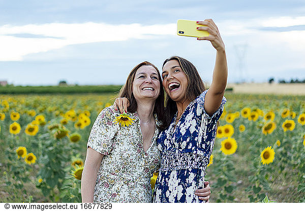 mother and daughter hugging taking a picture with the smartphone