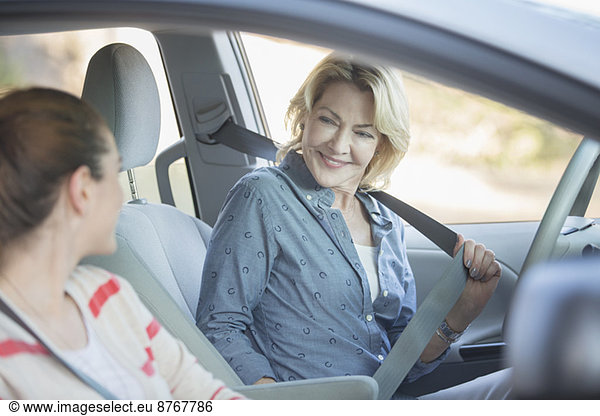 Mother and daughter inside car