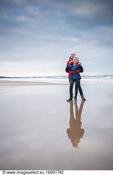 Mother and Daughter Reflection on the Beach