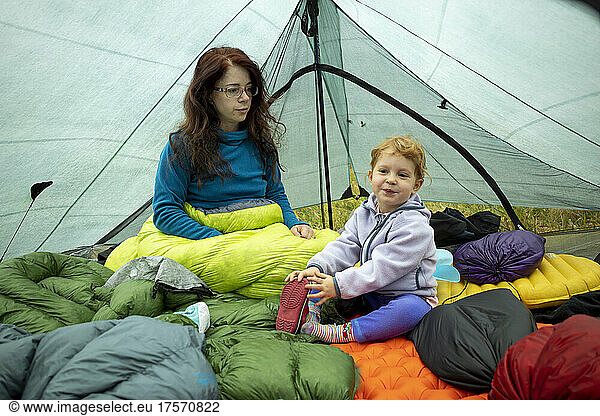 Mother and daughter relaxing inside the tent  Colorado