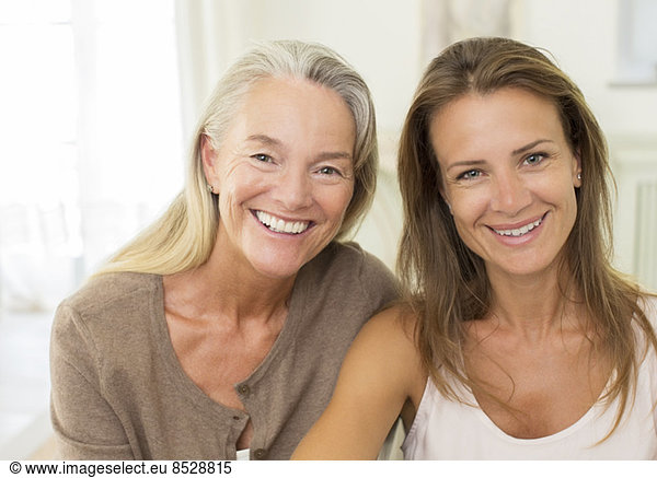 Mother and daughter smiling indoors