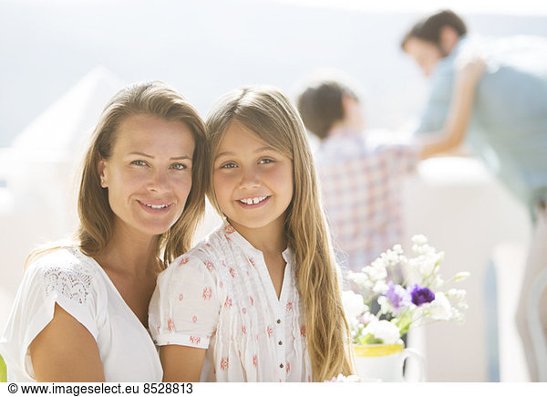 Mother and daughter smiling outdoors