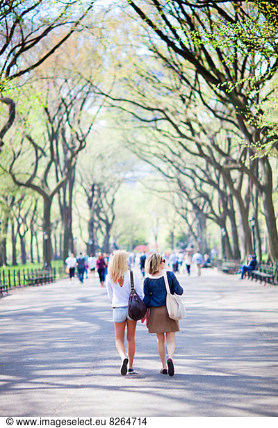Mother and daughter walking in Central Park