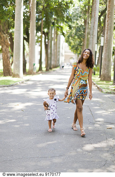 Mother and daughter walking in park