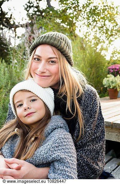 Mother and daughter wearing knitwear and hats  portrait