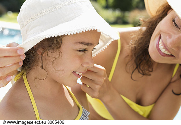 Mother and daughter wearing sunhats