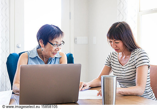 Mother and Daughter Working Together at Home