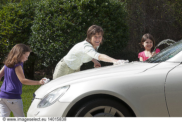 Mother and Daughters Washing Car