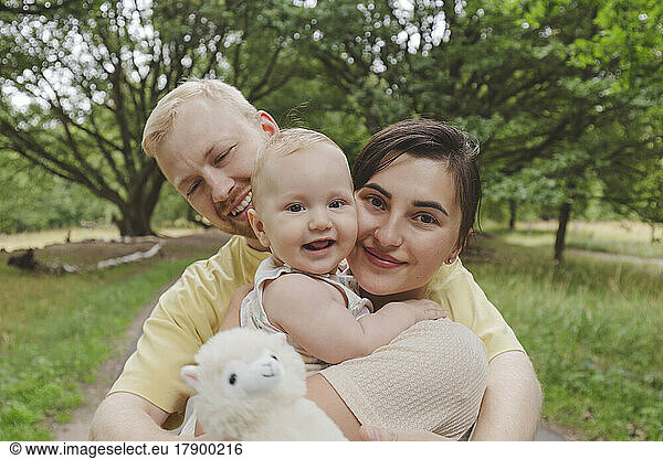 Mother and father with baby girl in park