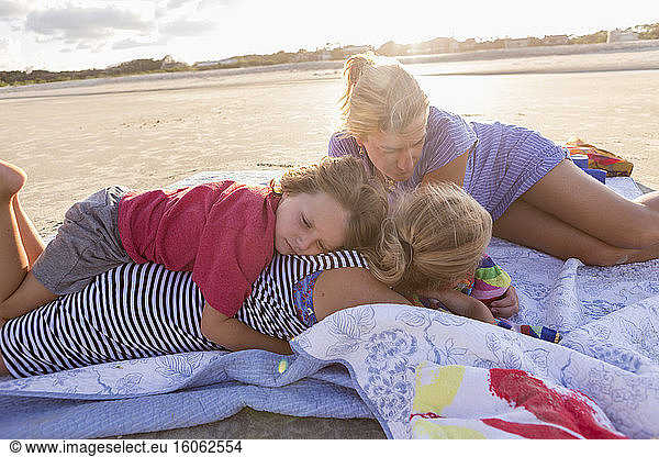 mother and her children on the beach at sunset Georgia