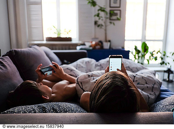 mother and son are watching smartphones