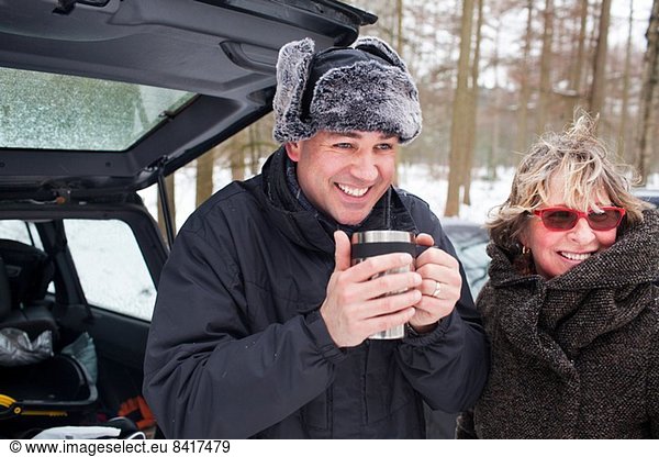 Mother and son having hot drink outside in winter