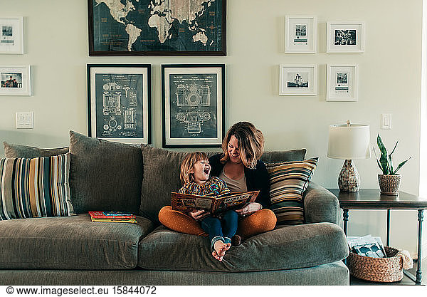 mother and young daughter reading