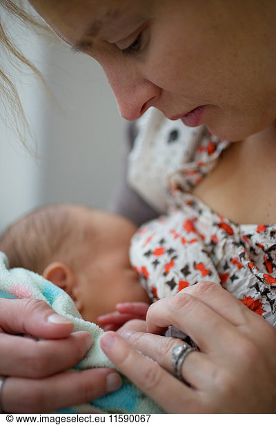 Mother breastfeeding newborn baby boy