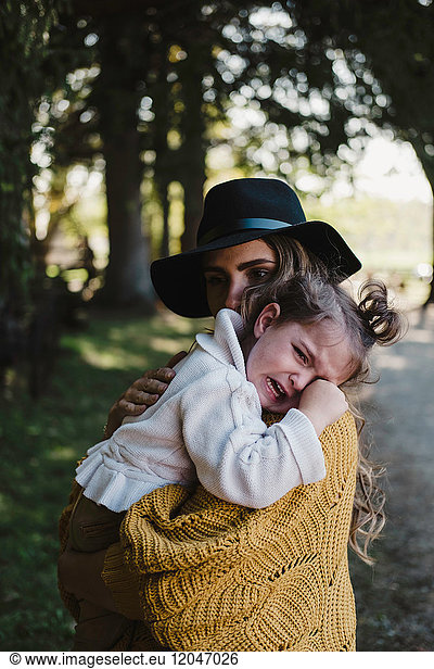 Mother comforting upset crying girl