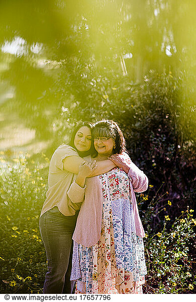 Mother & Daughter Embracing in Park in San Diego