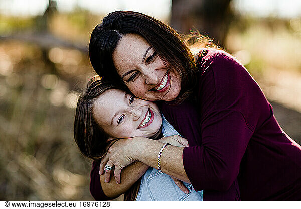 Mother & Daughter Embracing & Laughing at Park in Chula Vista