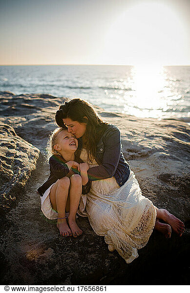 Mother & Daughter Snuggles on Beach at Sunset in San Diego