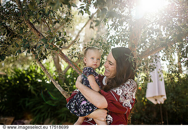 Mother & Daughter Standing Under Tree in California