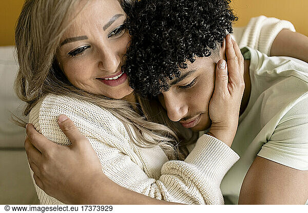 Mother embracing son at home
