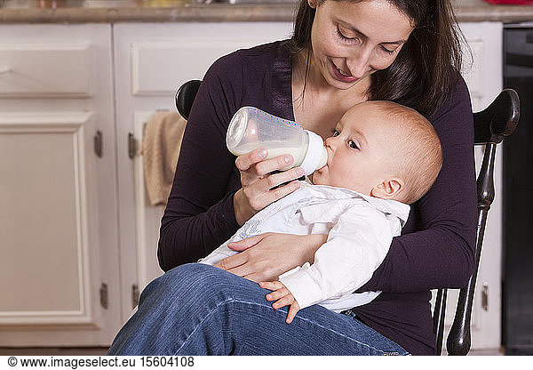 Mother feeding her son from bottle