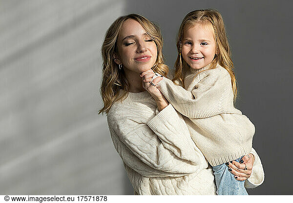 Mother holding her little daughter in hands
