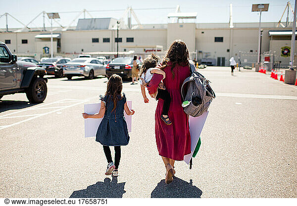Mother & Two Daughters Walking Onto Base for Military Homecoming