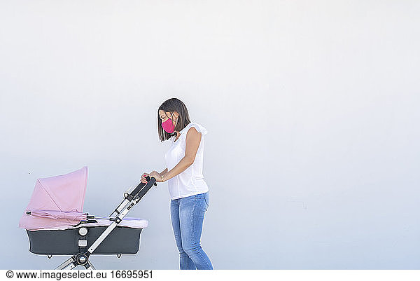 mother walking with her baby's stroller