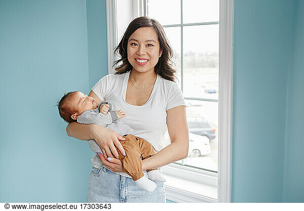 Mothers day holiday. Proud Chinese Asian mother with newborn baby boy.