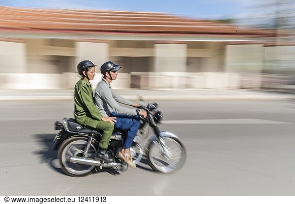 Motion blur of motorcycle riders in Nueva Gerona on Isla de la Juventud  Cuba.