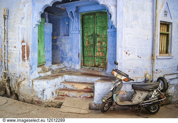 Motor scooter parked in front of traditional building entrance in Rajasthan  India.