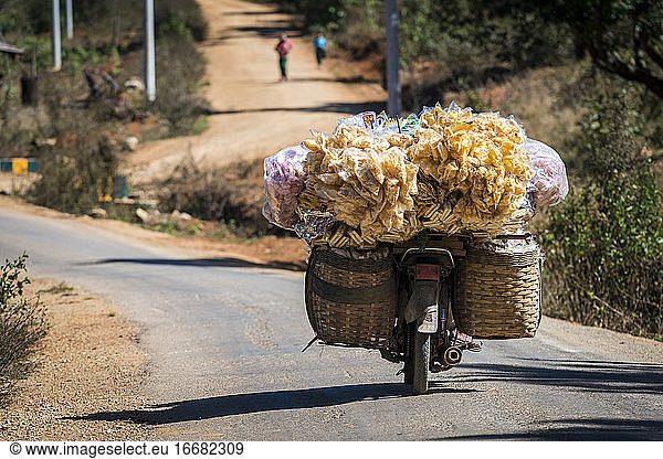 Motorcycle transporting goods during sunny day  Loikaw  Myanmar