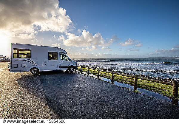 Motorhome at sunset parked in front of perfect waves