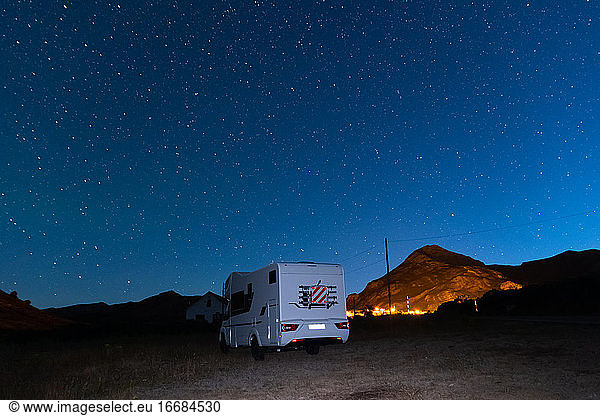 Motorhome parked Under Milky Way near Asturias  Spain. Travel campervan milky way.