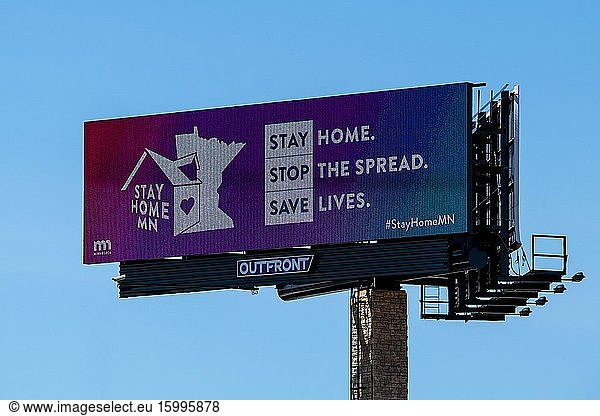 Mounds View  Minnesota  Billboard sign relaying message to stay home  stop the spread  save lives.