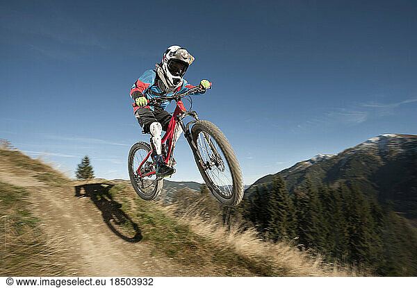 Mountain biker jumps over a bump  Saalbach-Hinterglemm  Zell am See  Salzburg  Austria
