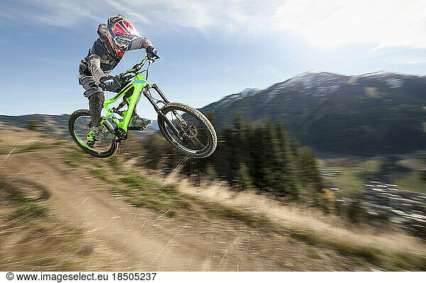 Mountain biker jumps over a bump  Saalbach-Hinterglemm  Zell am See  Salzburg  Austria