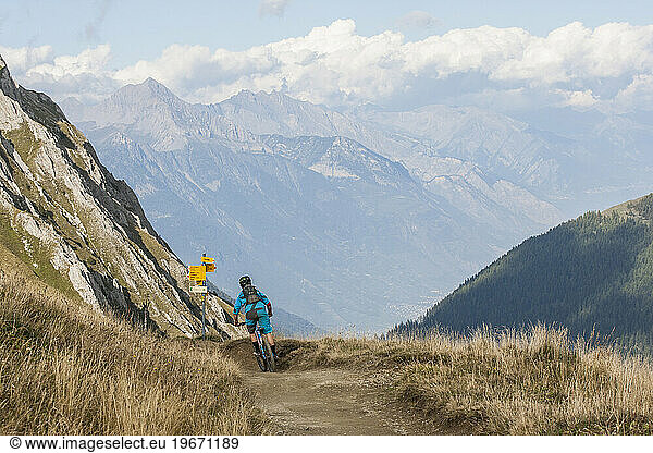 Mountain biker on dirt road in mountains  Chamonix  Haute-Savoie  France